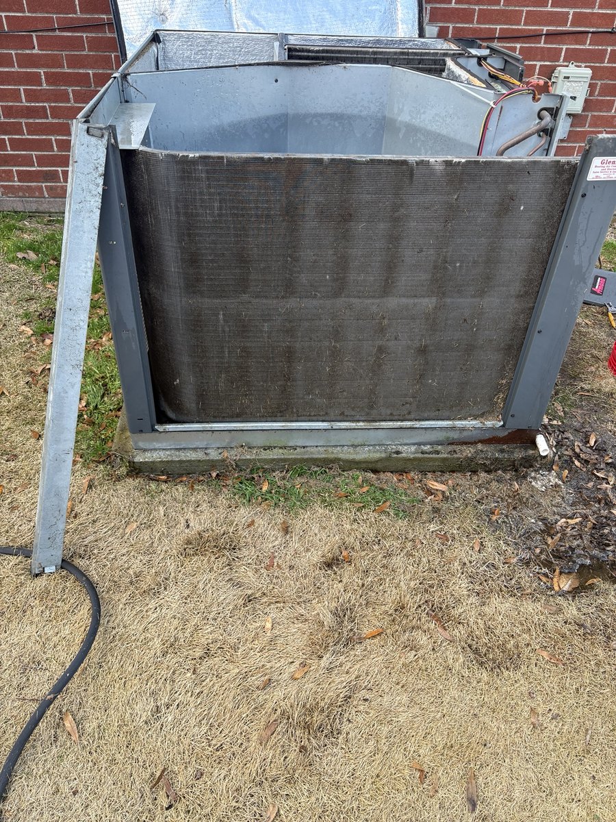 Outdoor condenser coil during professional cleaning