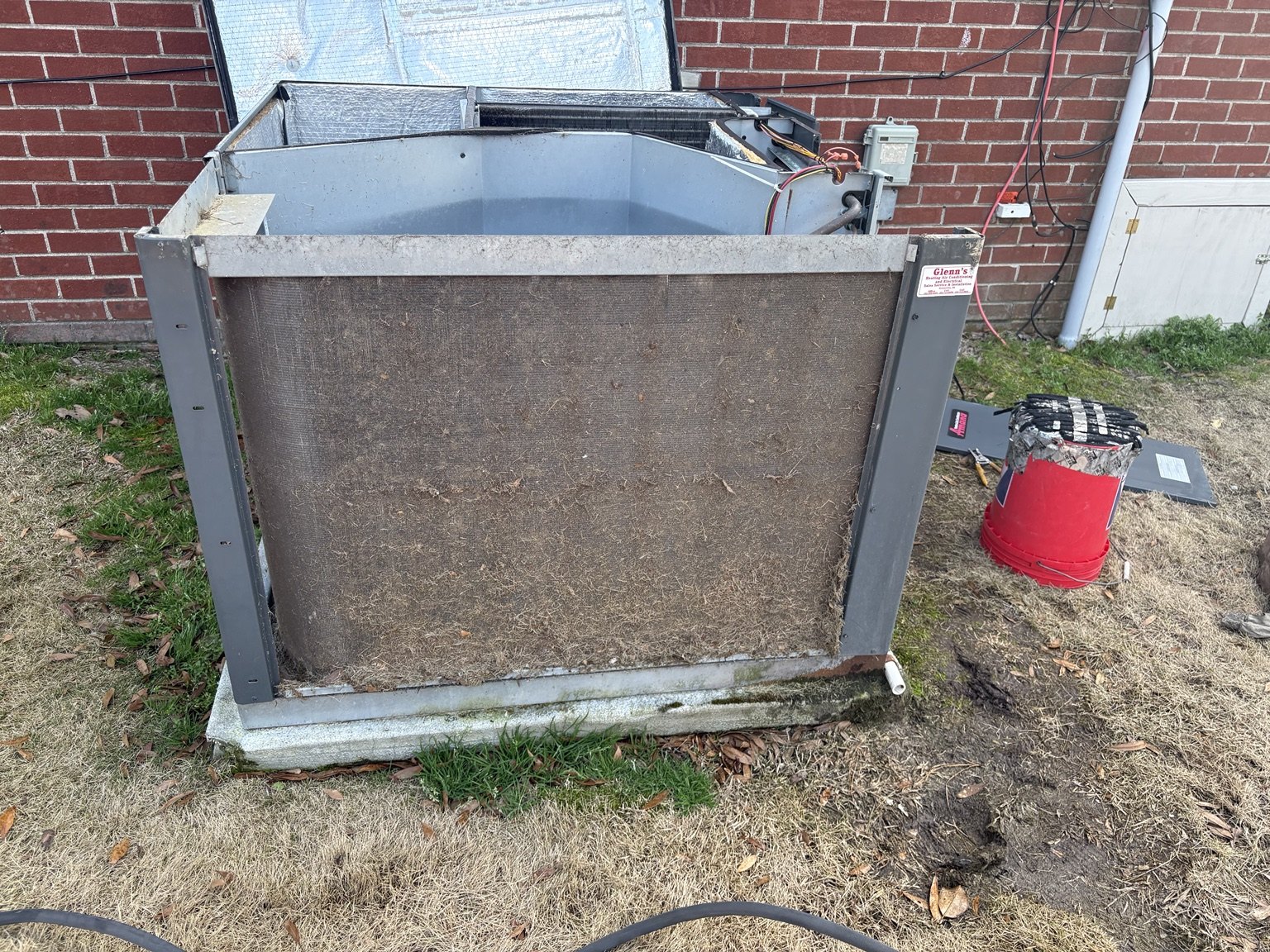 Outdoor condenser coil heavily restricted with dirt before cleaning