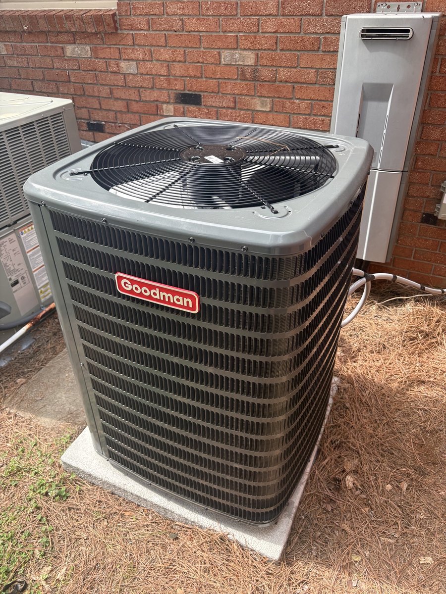 New Goodman outdoor HVAC condenser installed on a pad